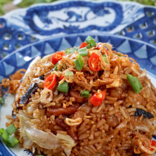 Portrait photo of Cantonese Cabbage and Mushroom Rice on a blue antique plate