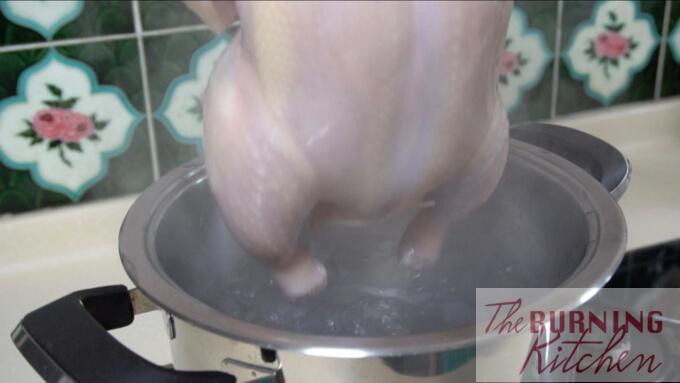 dunking the chicken in boiling water
