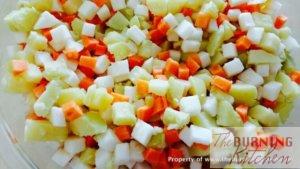 Diced carrots, potatoes and turnips on white plate