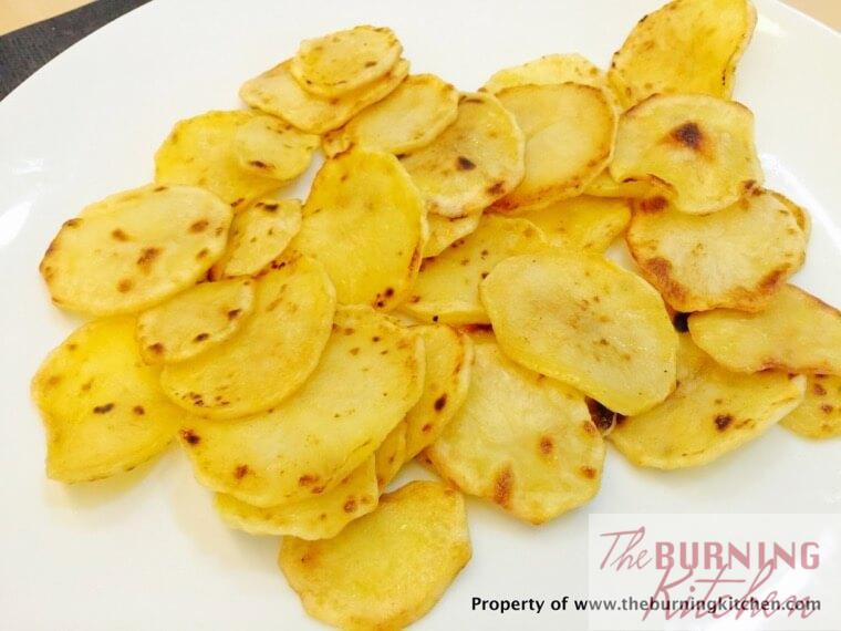 Pan fried potato slices on white plate