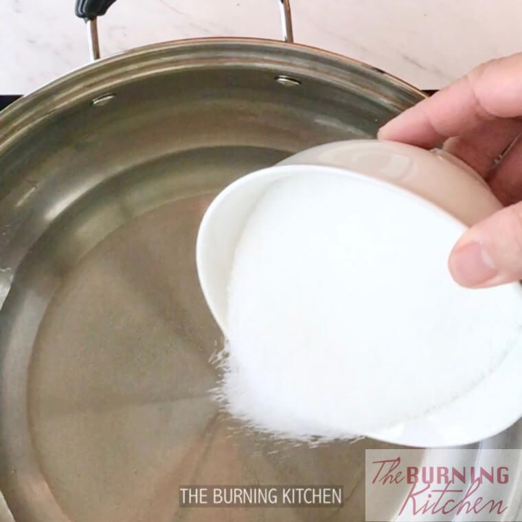 Pouring sugar into metal pot