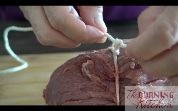 How to Tie a Roast: Tying a roast helps to retain a nice round shape during roasting, and also allows it to cook more evenly.