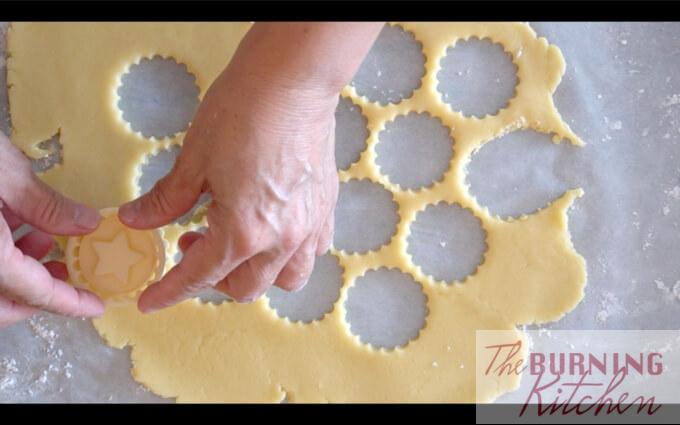 Cutting pineapple tart cookie shapes with cookie dough cutter