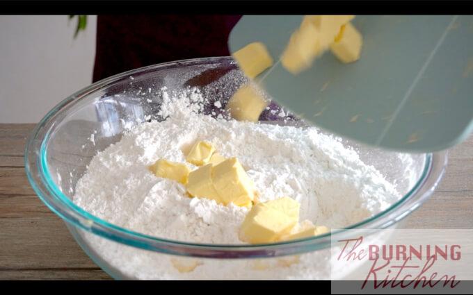 Throwing butter cubes into flour mixture
