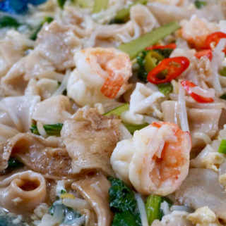 Portrait view of Wat Tan Hor Fun served with chilli and spring onions