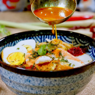 Bowl of Singapore laksa served with sambal chilli