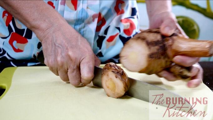 Slicing the blue ginger (galangal)