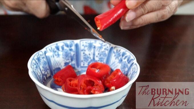 Cutting the large red chilli into pieces