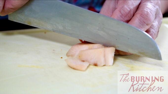 Slicing the galangal (blue ginger)